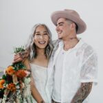 man and woman holding bouquet of flowers